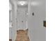 Hallway featuring tile floors, white walls, and access to multiple rooms at 1702 Valencia Blvd, Bartow, FL 33830