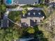 Aerial view of home featuring a well-manicured lawn and mature landscaping at 1819 Pawnee Trl, Lakeland, FL 33803