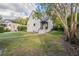 Backyard view of home featuring a grassy yard and mature trees at 1819 Pawnee Trl, Lakeland, FL 33803