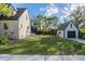 Lush backyard with verdant grass and a detached garage, offering a serene outdoor space at 1819 Pawnee Trl, Lakeland, FL 33803