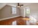 Bright bedroom with hardwood floors, built-in storage, and natural light from two windows at 1819 Pawnee Trl, Lakeland, FL 33803