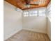 Cozy bedroom featuring a wood plank ceiling, fan, and multiple windows at 1819 Pawnee Trl, Lakeland, FL 33803