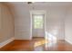 Bright bedroom with hardwood floors, built-in storage, and natural light from window at 1819 Pawnee Trl, Lakeland, FL 33803