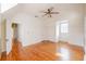 Bright bedroom features hardwood floors, ceiling fan, and sun-filled window at 1819 Pawnee Trl, Lakeland, FL 33803