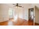 Sunlit bedroom with hardwood floors, ceiling fan, and built in storage at 1819 Pawnee Trl, Lakeland, FL 33803