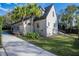 Attractive home with large sunroom featuring a lush green lawn and mature palm trees at 1819 Pawnee Trl, Lakeland, FL 33803