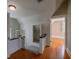 Upstairs hallway with hardwood floors and natural light leading to a bedroom at 1819 Pawnee Trl, Lakeland, FL 33803