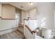 Carpeted staircase with wood railing and white trim at 1819 Pawnee Trl, Lakeland, FL 33803