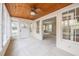 Bright sunroom featuring a wood-paneled ceiling, a ceiling fan, and several windows offering a scenic view of the outdoors at 1819 Pawnee Trl, Lakeland, FL 33803