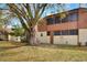 Backyard view with a large tree and a screened-in patio at 1880 N Crystal Lake Dr # 4, Lakeland, FL 33801