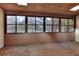 Enclosed porch featuring wood ceiling, wood floor, and windows overlooking the trees at 1880 N Crystal Lake Dr # 4, Lakeland, FL 33801