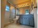 Bathroom featuring a shower, toilet, vanity and cabinet, and patterned wallpaper at 2021 Windward Pass, Lakeland, FL 33813