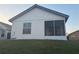 A home's exterior with screened in porch and lawn at 2021 Windward Pass, Lakeland, FL 33813