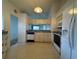 Kitchen with white appliances, cabinets, tile flooring, and wallpaper at 2021 Windward Pass, Lakeland, FL 33813