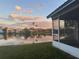 A serene lake view with palm trees and reflections of the sky and nearby houses at 2021 Windward Pass, Lakeland, FL 33813