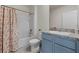 Charming bathroom featuring a blue vanity and shower with tub at 211 Emanuelle Dr, Winter Haven, FL 33884