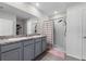 Bathroom featuring double sinks, granite countertops, a shower, and tile flooring at 211 Emanuelle Dr, Winter Haven, FL 33884