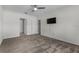 Bedroom featuring a ceiling fan, carpet flooring, a window, a mounted tv, and neutral colors at 211 Emanuelle Dr, Winter Haven, FL 33884