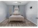 Bright bedroom featuring light blue walls, carpet flooring, and a ceiling fan at 211 Emanuelle Dr, Winter Haven, FL 33884