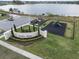 Aerial of Villa Mar community entrance sign, playground, parking area, and lush landscaping at 211 Emanuelle Dr, Winter Haven, FL 33884