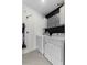 Well-lit laundry room features stylish black-and-white patterned accent wall and new washer and dryer at 211 Emanuelle Dr, Winter Haven, FL 33884