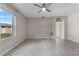 Open living space featuring tile flooring, light colored walls, a ceiling fan, and natural light at 211 Emanuelle Dr, Winter Haven, FL 33884