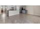 Open living space showcasing tile flooring, gray kitchen cabinets, stainless steel appliances, and granite countertops at 211 Emanuelle Dr, Winter Haven, FL 33884