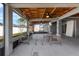 Covered patio with wood plank ceiling, fan, and outdoor seating area with view to backyard at 211 Emanuelle Dr, Winter Haven, FL 33884