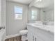 Updated bathroom features a marble vanity, wood-look floor, and a tiled shower at 22 S Cherokee Ave, Fort Meade, FL 33841