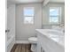 Updated bathroom features a marble vanity, wood-look floor, and a tiled shower at 22 S Cherokee Ave, Fort Meade, FL 33841