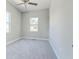 Bright bedroom with neutral carpet and a ceiling fan at 22 S Cherokee Ave, Fort Meade, FL 33841