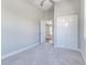 Bright bedroom with neutral carpet and a double door closet at 22 S Cherokee Ave, Fort Meade, FL 33841