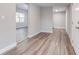 Bright entryway with wood-look flooring that transitions into an adjacent living space at 22 S Cherokee Ave, Fort Meade, FL 33841