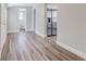 Hallway featuring wood-look flooring with access to the kitchen and other rooms at 22 S Cherokee Ave, Fort Meade, FL 33841