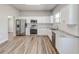 Kitchen features stainless steel appliances, white cabinetry, and marble countertops at 22 S Cherokee Ave, Fort Meade, FL 33841