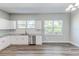 Kitchen with stainless steel dishwasher and granite countertop, featuring bright, natural light at 22 S Cherokee Ave, Fort Meade, FL 33841