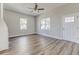 Bright living room featuring beautiful hardwood floors, lots of natural light and views of the front yard at 22 S Cherokee Ave, Fort Meade, FL 33841