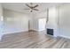 Bright living room features a decorative brick fireplace and modern ceiling fan at 22 S Cherokee Ave, Fort Meade, FL 33841