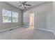 Spacious main bedroom with a ceiling fan and plush carpeting that leads to the ensuite bath at 22 S Cherokee Ave, Fort Meade, FL 33841