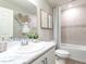 Bathroom featuring a marble-topped vanity, large mirror, and a shower-tub combination at 2218 Oldham Ct, Haines City, FL 33844