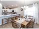 Dining room with adjacent island and kitchen, decorated with modern furnishings at 2218 Oldham Ct, Haines City, FL 33844