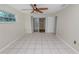 Bedroom with tile floors, ceiling fan and a view into the sunroom at 2330 Creek Side Dr, Lakeland, FL 33811