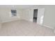 View of a neutral bedroom featuring tile floors and an open doorway to another room at 2330 Creek Side Dr, Lakeland, FL 33811