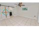 Bedroom with tile floors, ceiling fan and a barn door at 2330 Creek Side Dr, Lakeland, FL 33811