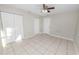 Bright bedroom featuring a ceiling fan, white walls, and tiled floors at 2330 Creek Side Dr, Lakeland, FL 33811