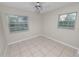 Bright bedroom with tile flooring, and two windows providing natural light at 2330 Creek Side Dr, Lakeland, FL 33811