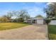 Charming single-story home featuring a metal roof, stone accents, and a long driveway at 2330 Creek Side Dr, Lakeland, FL 33811