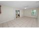 Bright living room with tile floors, sliding glass door, and a ceiling fan at 2330 Creek Side Dr, Lakeland, FL 33811