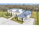 Aerial view of a modern home with solar panels, a screened pool, and manicured grounds at 275 Canterwood Ln, Mulberry, FL 33860