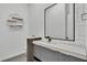 Modern bathroom featuring a gray vanity, large mirror, and subway tile walls at 275 Canterwood Ln, Mulberry, FL 33860